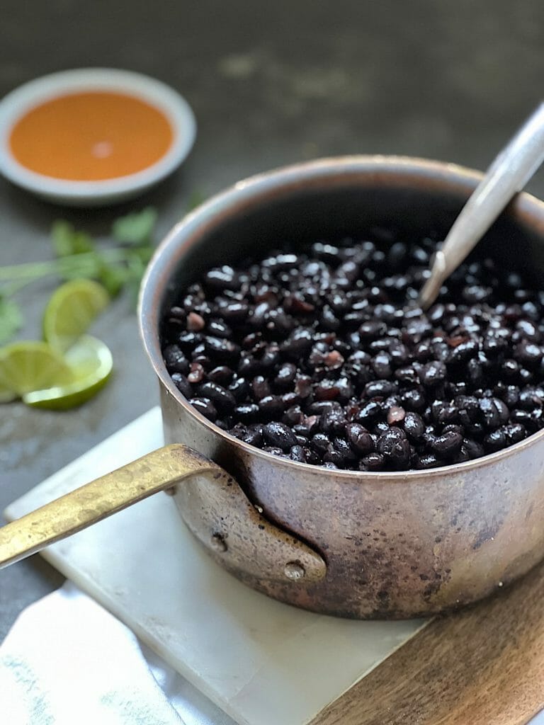 pot of black beans with a spoon