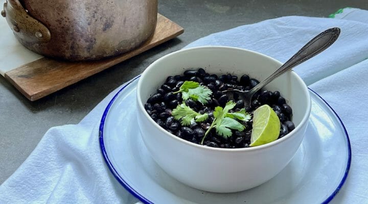 Bowl of black beans with pot