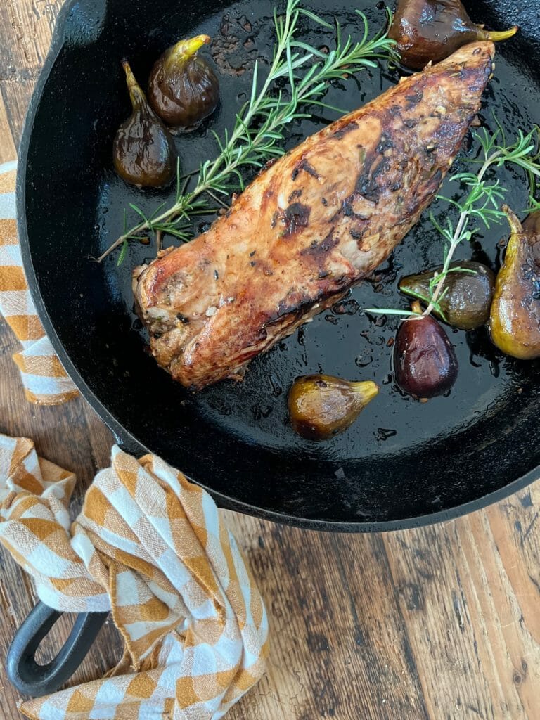 cast iron skillet with pork and rosemary and figs