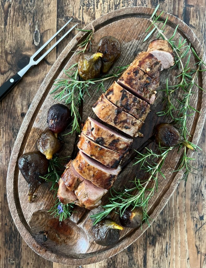 Sliced pork tenderloin on a cutting board