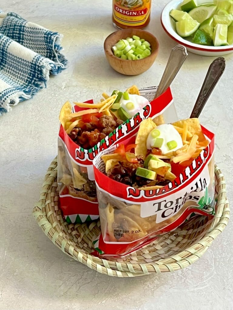  the best walking taco recipe with forks and garnishes