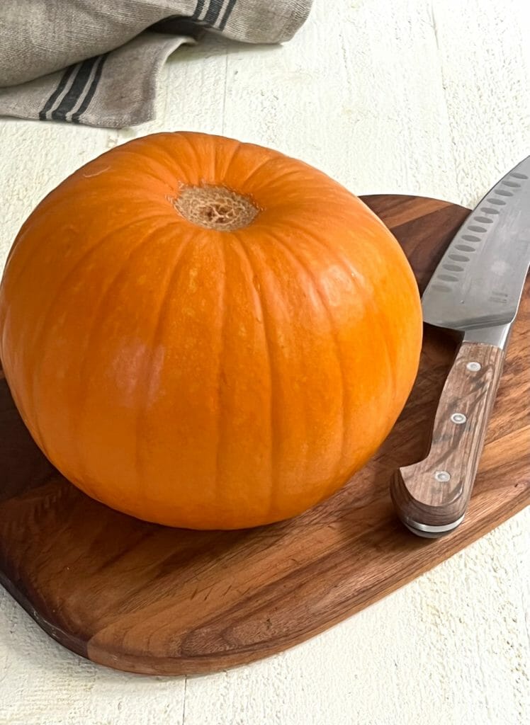 Sugar Pumpkin on a cutting board with a knife