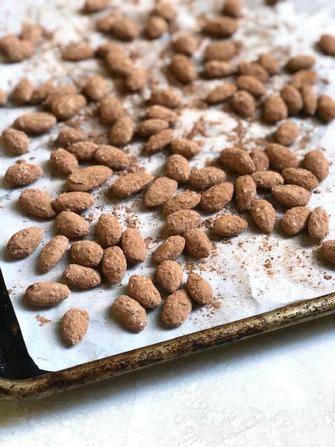 sheet pan of cocoa covered almonds