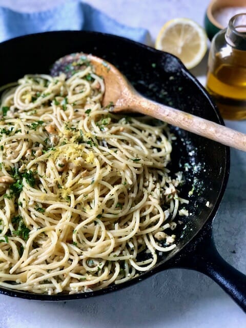 Cast iron skillet with spaghetti and clams