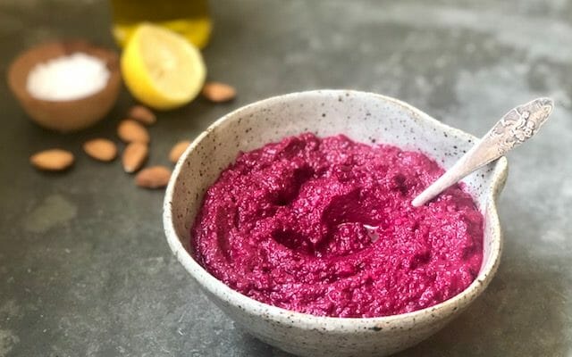 Beet Hummus in bowl with spoon