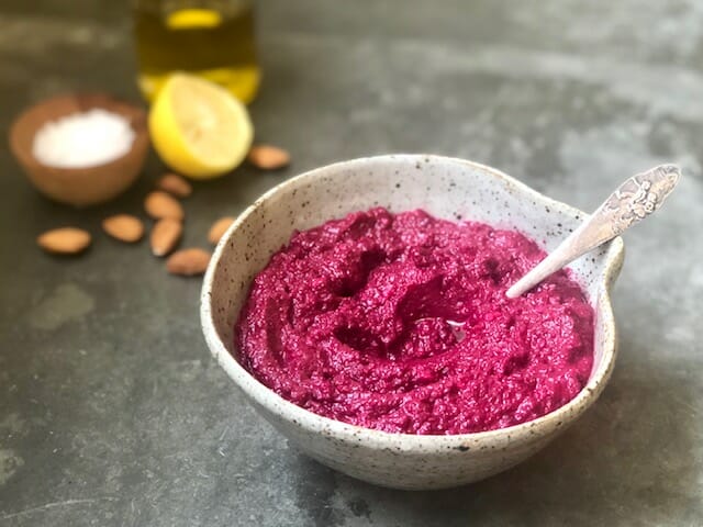 Beet Hummus in bowl with spoon