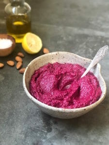 Beet Hummus in bowl with spoon