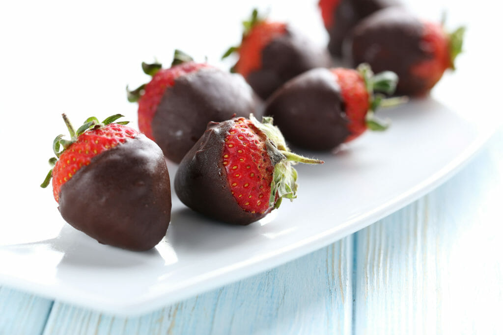 Chocolate covered strawberries on a white plate