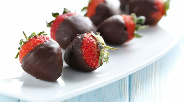 Chocolate covered strawberries on a white plate