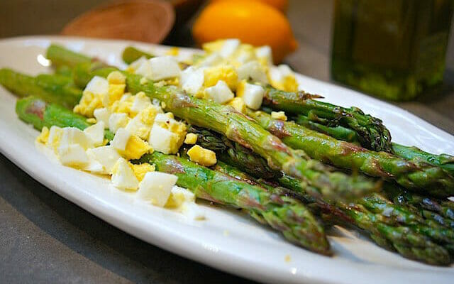 Roasted Asparagus on a plate with chopped egg on top