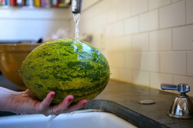 a melon being washed