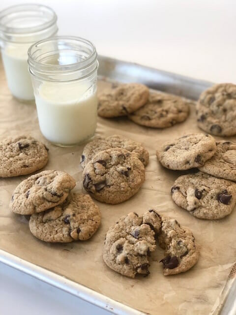 Healthier Chocolate Chip Cookies with glasses of milk