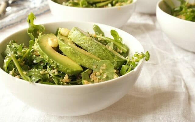 Salad in a white bowl with avocado and quinoa. Healthy anti-inflammatory recipe