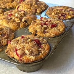 whole-grain cranberry streusel muffins in a muffin tin