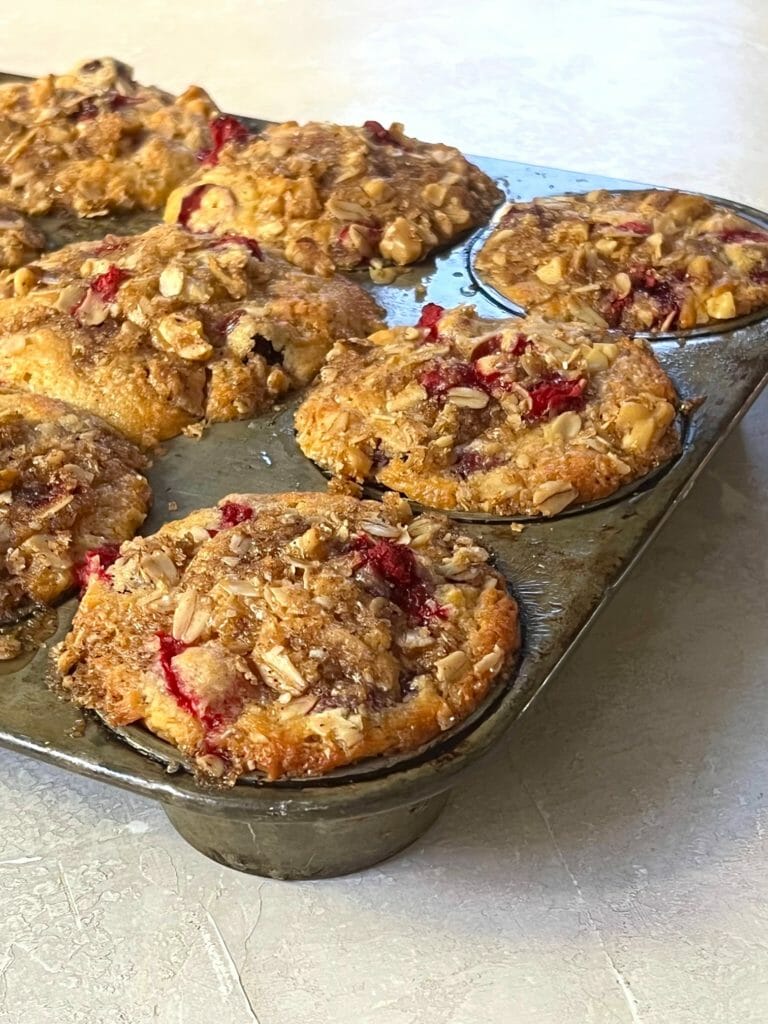 whole-grain cranberry streusel muffins in a muffin tin