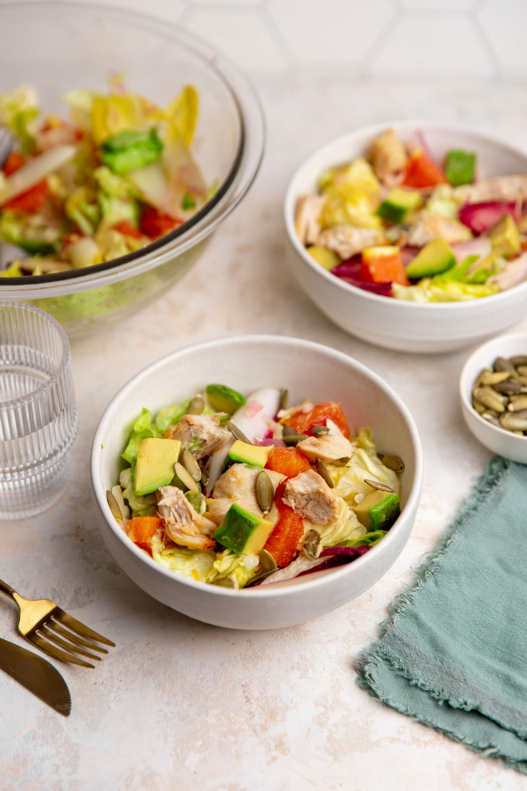 two bowls of healthy salad with chicken and avocado 