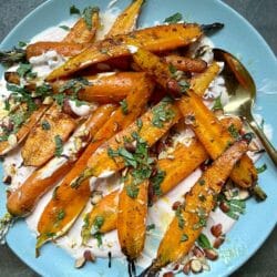 Roasted Carrots with Harissa Yogurt on a blue plate