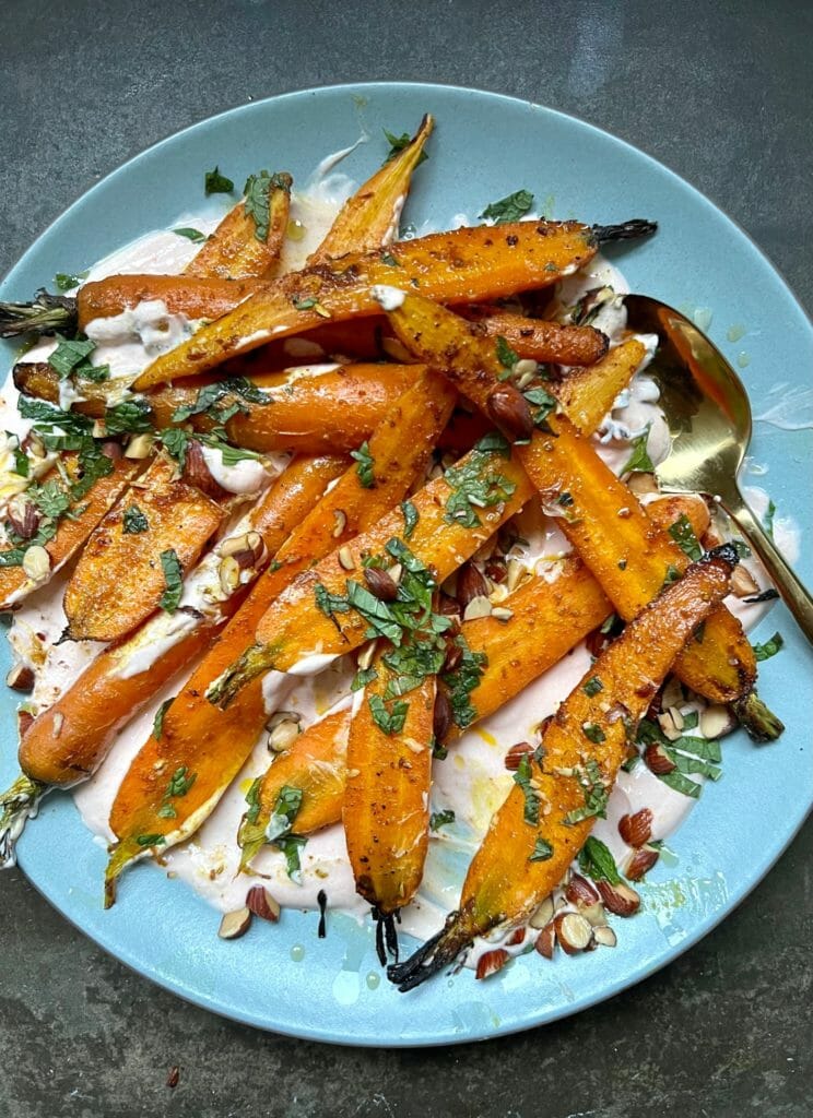 Roasted Carrots with Harissa Yogurt on a blue plate