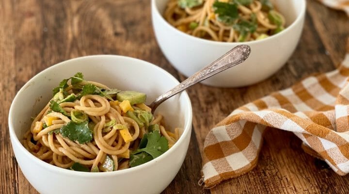 Noodles with peanut sauce in white bowls