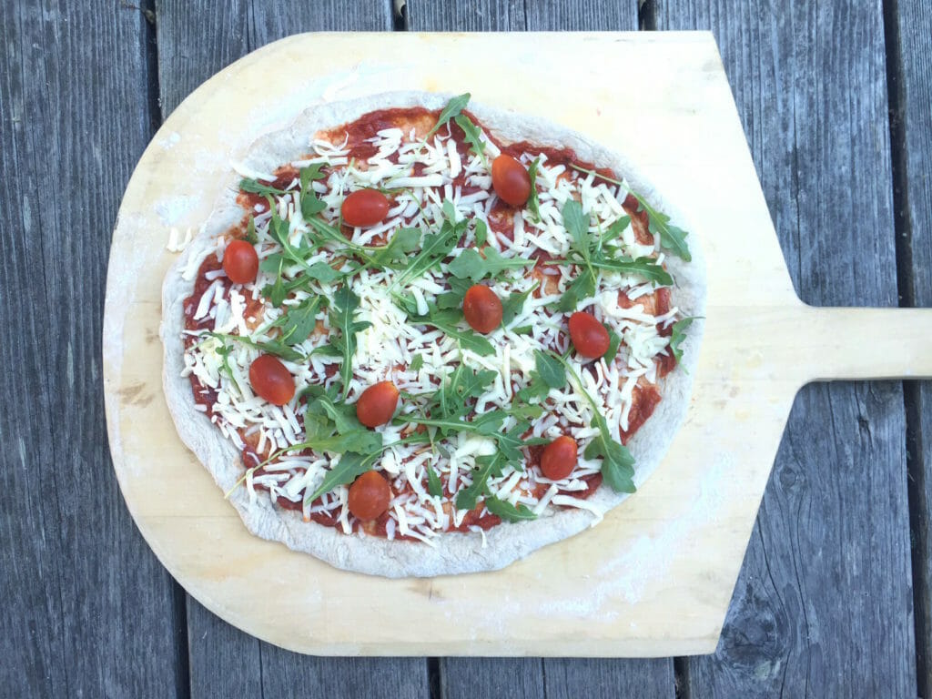 Pizza on the grill using a pizza peel