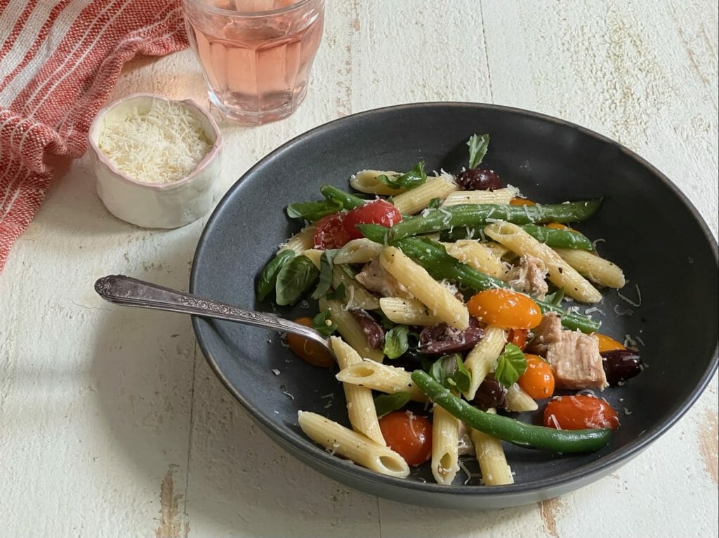 bowl of easy nicoise pasta with glass of rose