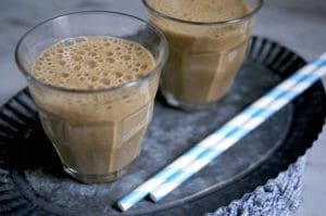 Two glasses of healthy Peanut Butter Chocolate Smoothie with straws
