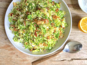 Shaves Brussels Sprouts Salad with Almonds in a Bowl