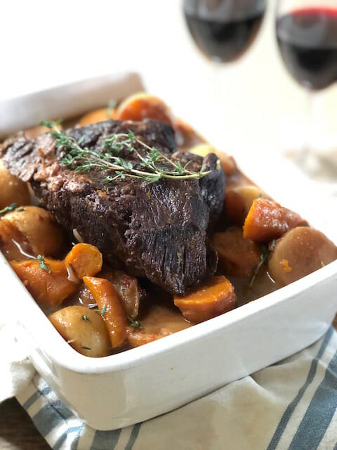 Slow Cooker Pot Roast with Vegetables in a white casserole