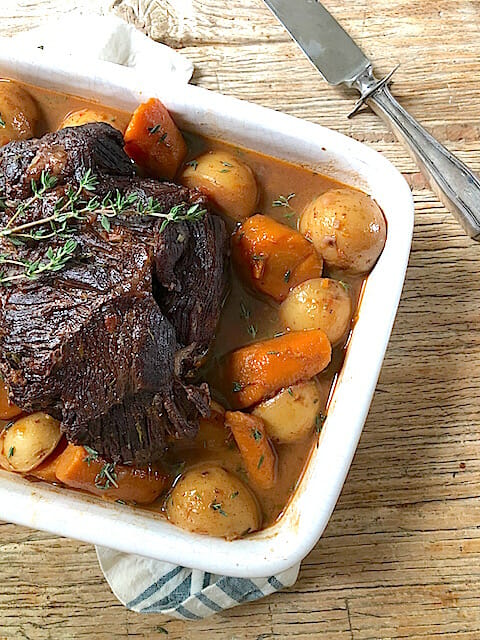 A White dish with Slow Cooker Pot Roast with Vegetables