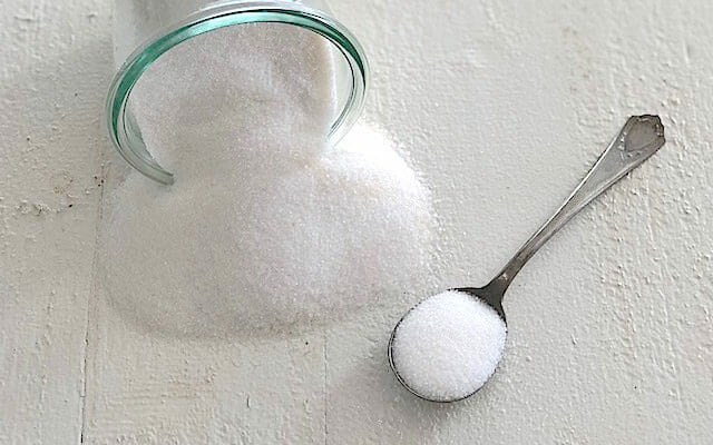 Sugar spilled on the counter as part of healthy store bought snacks