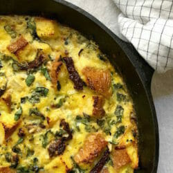 Egg and spinach strata in a cast iron skillet