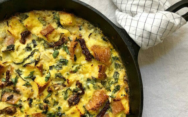 Egg and spinach strata in a cast iron skillet