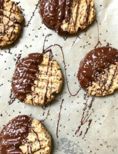 Tahini almond butter cookies dunked in chocolate with drizzled chocolate