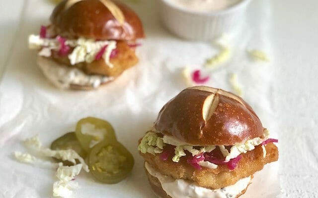 Fish sliders on pretzel buns with pickled jalapenos