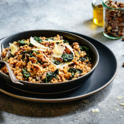 Instant Pot Farro Risotto with parmesan and kale in a shallow grey bowl