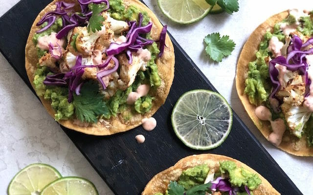 cauliflower tostadas with avocado, red cabbage, and lime