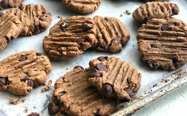 Peanut butter chocolate chip cookies on a sheet pan 