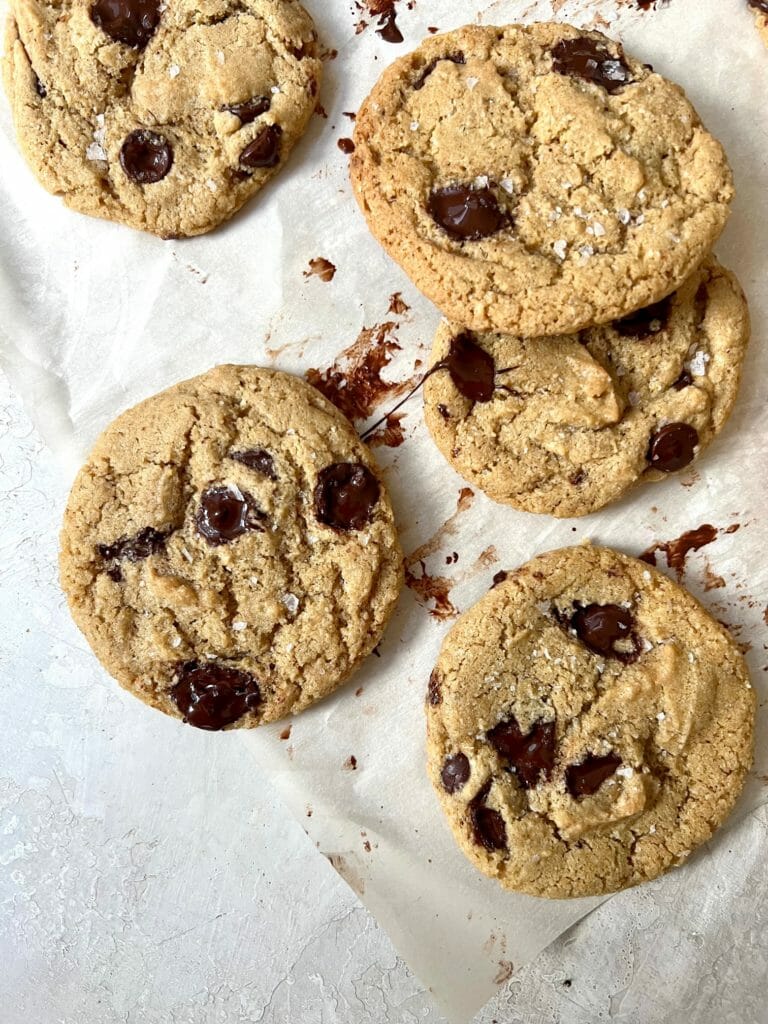 five healthier chocolate chip cookies on parchment