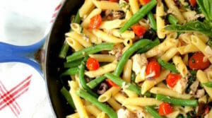 pasta in a cast iron skillet with tuna nicoise ingredients