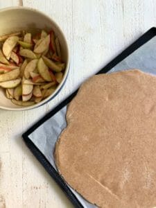 rolled out dough and sliced apples for tart