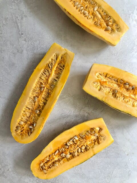 Halved delicata squash on the counter