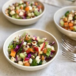 Flexible Chopped Winter Salad in white bowls with forks