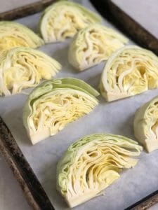 wedges of raw cabbage on a sheet pan