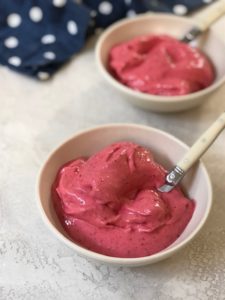 two bowls of raspberry sorbet with spoons