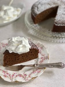 wedge of gingerbread cake with whipped cream