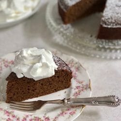 wedge of gingerbread cake with whipped cream