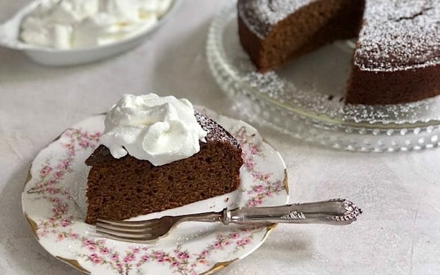 Pumpkin Molasses Gingerbread Cake cup into a wedge and served with whipped cream
