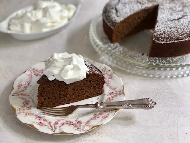 Pumpkin Molasses Gingerbread Cake cup into a wedge and served with whipped cream