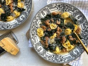 bowls of brothy pasta with Parmesan