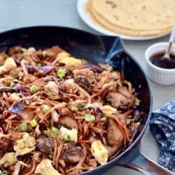 Skillet of moo shu vegetables with tortillas and sauce